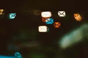 Envelope shaped bokeh lights in blue, orange, and white against a dark background