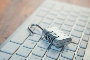 A combination lock rests on a computer keyboard